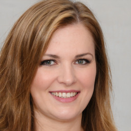 Joyful white young-adult female with long  brown hair and green eyes