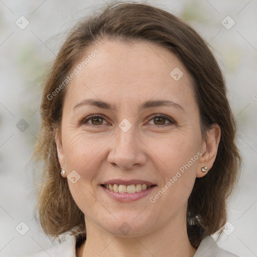 Joyful white adult female with medium  brown hair and brown eyes