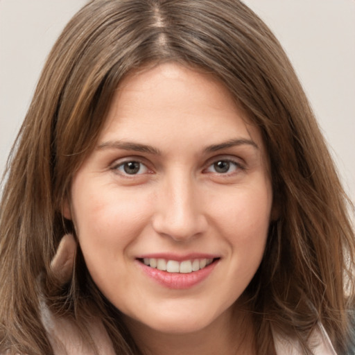 Joyful white young-adult female with long  brown hair and brown eyes