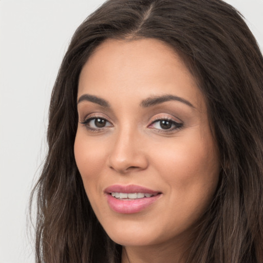 Joyful white young-adult female with long  brown hair and brown eyes