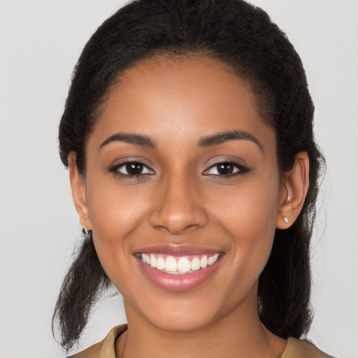 Joyful latino young-adult female with long  brown hair and brown eyes