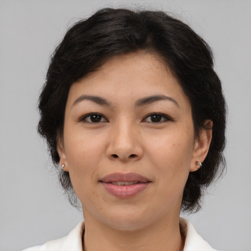 Joyful asian adult female with medium  brown hair and brown eyes