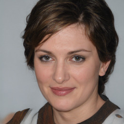 Joyful white adult female with medium  brown hair and brown eyes