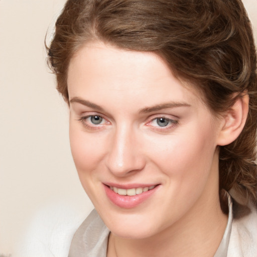 Joyful white young-adult female with medium  brown hair and blue eyes