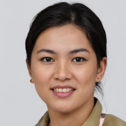 Joyful asian young-adult female with medium  brown hair and brown eyes