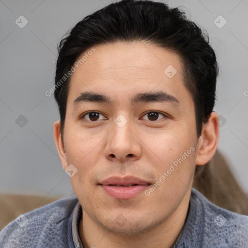 Joyful asian young-adult male with short  brown hair and brown eyes