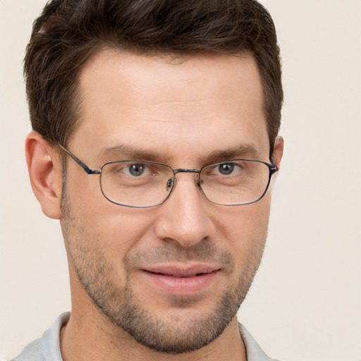 Joyful white adult male with short  brown hair and brown eyes