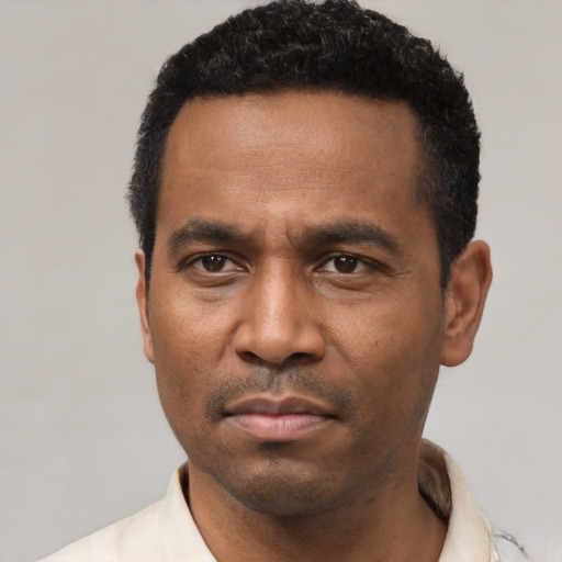 Neutral latino adult male with short  black hair and brown eyes
