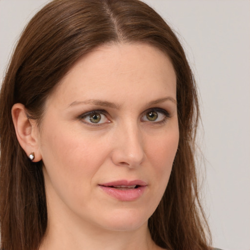 Joyful white young-adult female with long  brown hair and green eyes