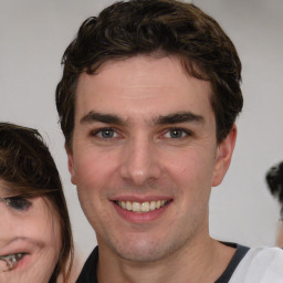 Joyful white young-adult male with medium  brown hair and brown eyes