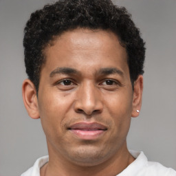 Joyful latino young-adult male with short  brown hair and brown eyes