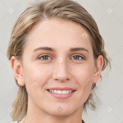 Joyful white young-adult female with medium  brown hair and blue eyes