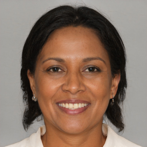 Joyful black adult female with medium  brown hair and brown eyes