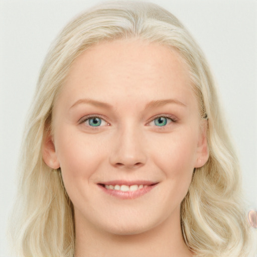 Joyful white young-adult female with long  blond hair and blue eyes