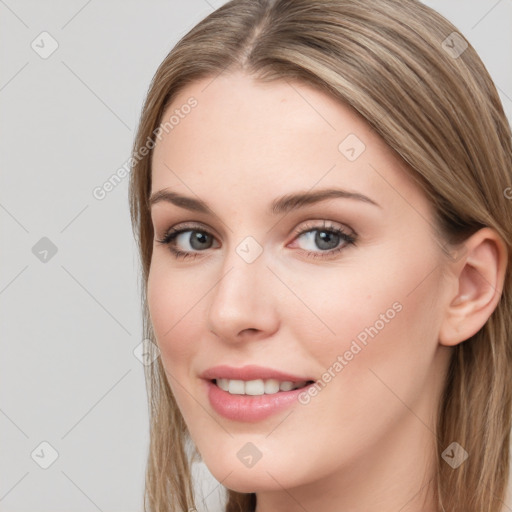 Joyful white young-adult female with long  brown hair and blue eyes