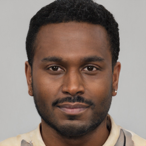 Joyful latino young-adult male with short  brown hair and brown eyes