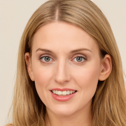 Joyful white young-adult female with long  brown hair and blue eyes