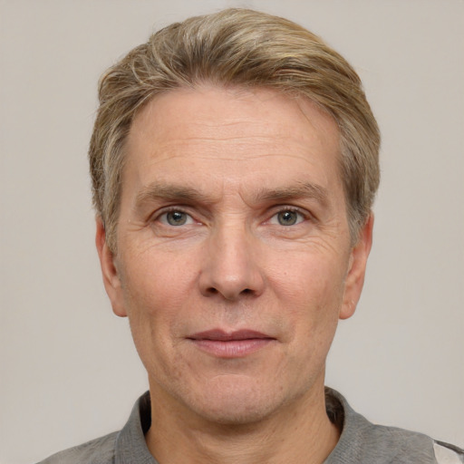 Joyful white adult male with short  brown hair and grey eyes