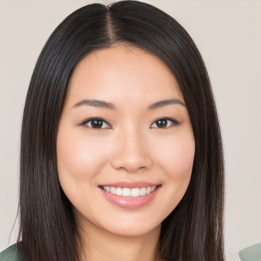 Joyful asian young-adult female with long  brown hair and brown eyes