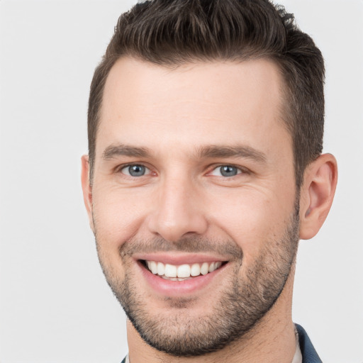 Joyful white young-adult male with short  brown hair and brown eyes