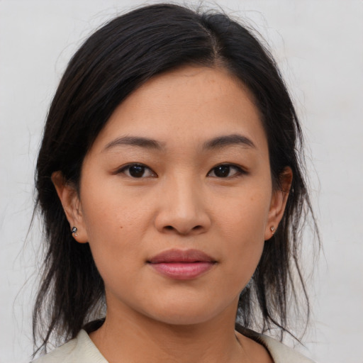 Joyful asian young-adult female with medium  brown hair and brown eyes
