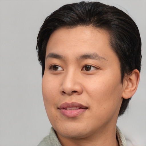 Joyful asian young-adult male with short  brown hair and brown eyes
