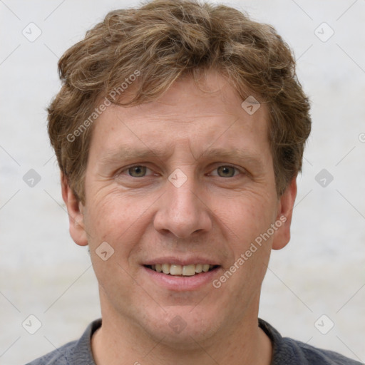 Joyful white adult male with short  brown hair and grey eyes