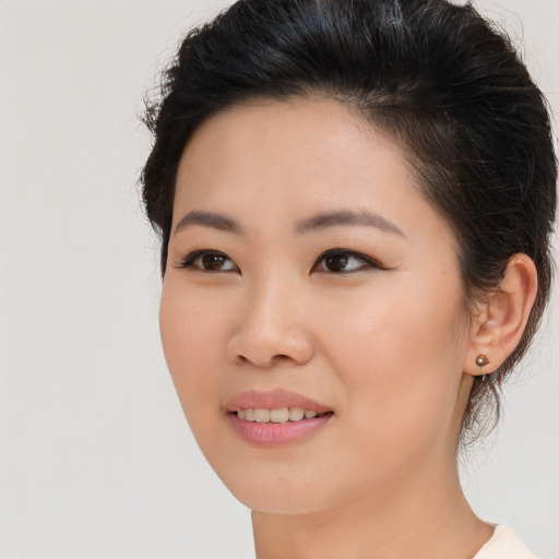 Joyful asian young-adult female with long  brown hair and brown eyes