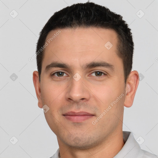 Joyful white young-adult male with short  black hair and brown eyes