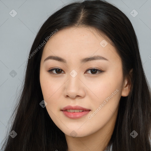 Joyful asian young-adult female with long  brown hair and brown eyes