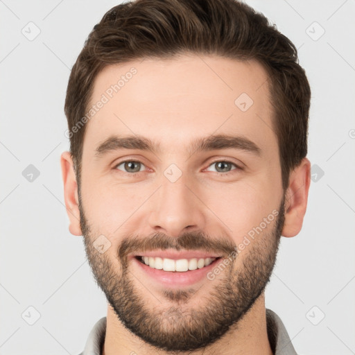 Joyful white young-adult male with short  brown hair and brown eyes