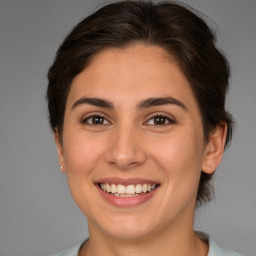 Joyful white young-adult female with medium  brown hair and brown eyes