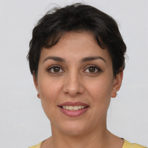 Joyful white young-adult female with short  brown hair and brown eyes