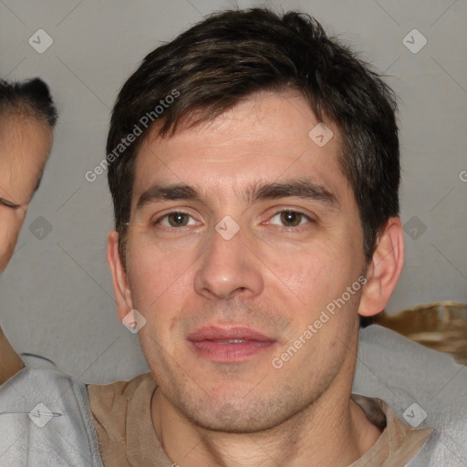 Joyful white young-adult male with short  brown hair and brown eyes