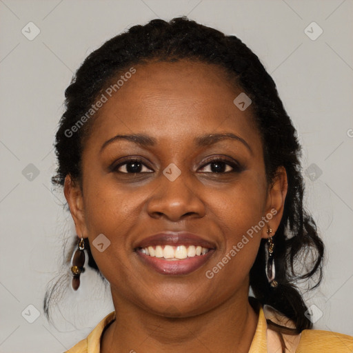 Joyful black young-adult female with long  black hair and brown eyes