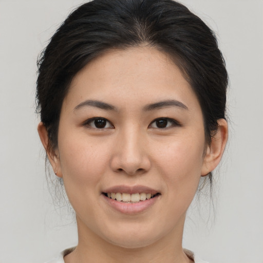 Joyful asian young-adult female with medium  brown hair and brown eyes