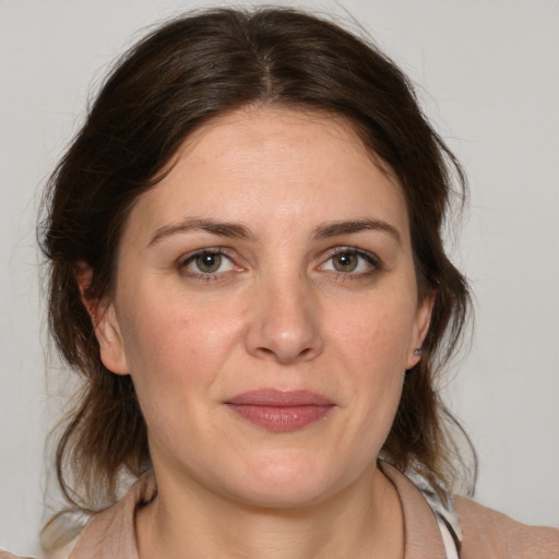 Joyful white adult female with medium  brown hair and brown eyes