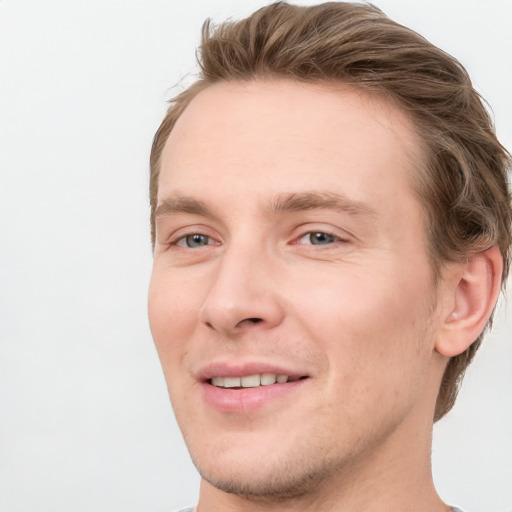 Joyful white young-adult male with short  brown hair and blue eyes