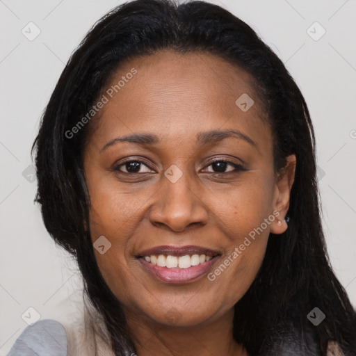 Joyful black young-adult female with long  brown hair and brown eyes