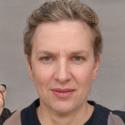 Joyful white adult female with short  brown hair and blue eyes