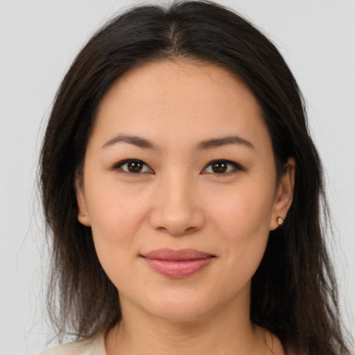 Joyful latino young-adult female with long  brown hair and brown eyes