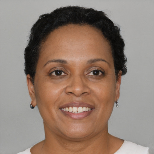 Joyful black adult female with short  brown hair and brown eyes