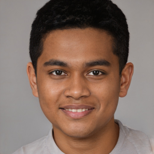 Joyful black young-adult male with short  black hair and brown eyes