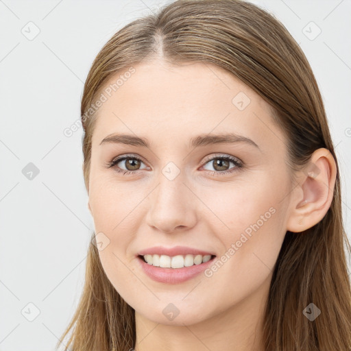 Joyful white young-adult female with long  brown hair and brown eyes