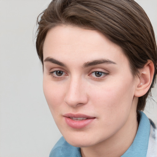 Joyful white young-adult female with medium  brown hair and blue eyes