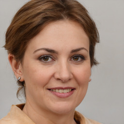 Joyful white adult female with medium  brown hair and brown eyes