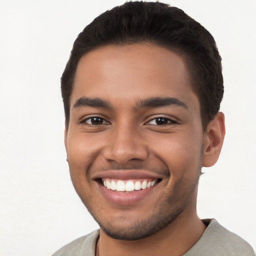 Joyful latino young-adult male with short  brown hair and brown eyes