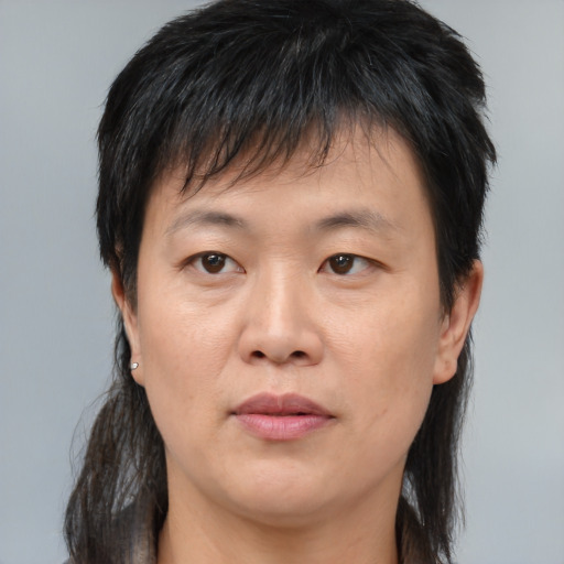 Joyful asian young-adult male with medium  brown hair and brown eyes