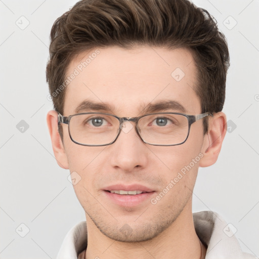 Joyful white young-adult male with short  brown hair and grey eyes