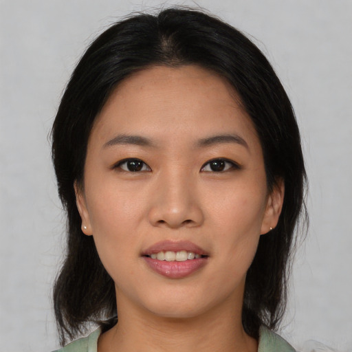 Joyful asian young-adult female with medium  black hair and brown eyes